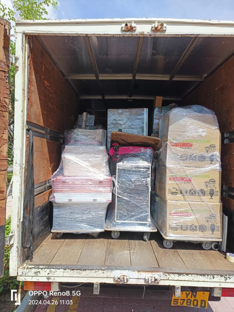 Xpress Movers truck with securely packed furniture and boxes in Singapore